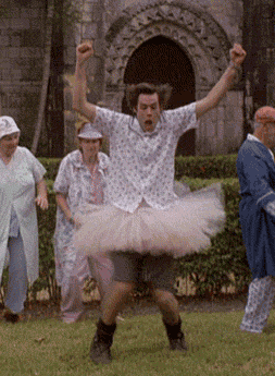 Movie gif. Actor Jim Carrey as Ace Ventura dances in a pink tutu. 
