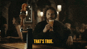 Ad gif. A man sits at a bar and laughs as he holds his glass of beer near his face. The little Shock Top orange mascot sits on a Beer tap handle also laughing, Text, “That’s true.”