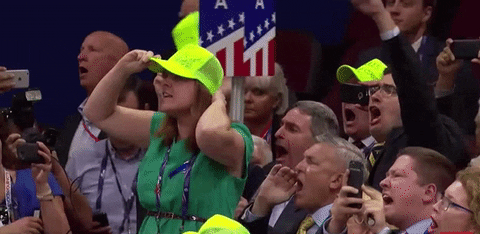 Political gif. A woman at the Republican National Convention stands on a chair and boos, lifting her hands in the air to put both thumbs down. 