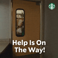 Sponsored gif. Barista wearing a green Starbucks apron walks through the swinging door of a storage room while precariously balancing five gallons of milk in his arms. Text reads, “Help is on the way!”