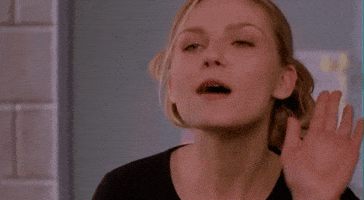 Movie gif. Kirsten Dunst as Torrance Shipman in Bring It On has a sassy look on her face as she waves her hand open and close, and says, “Buh Bye.”
