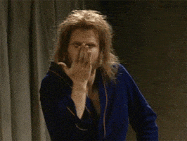SNL gif. Will Ferrell wearing a bathrobe and a disheveled beard and wig. He leans forward toward us, blowing a kiss and pointing to his winking eye as he says, "Wink."