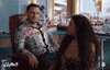 TV gif. Jack Kesy as Roller on Claws pumps his fists in front of his face while talking as Niecy Nash as Desna watches him, then looks forward, confused.