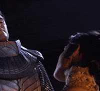 TV gif. Morena Baccarin as Adria from the show Stargate SG-1. She looks up to someone with glowing eyes and seems to break his neck with a look. 