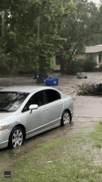 Trash Can Floats Down Flooded Waco Street