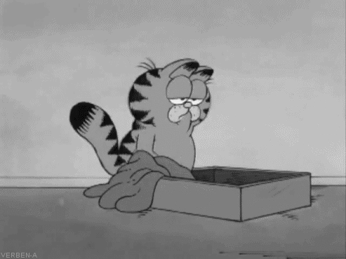Cartoon gif. In black and white, a sleepy Garfield trudges to his bed and flops down face first.