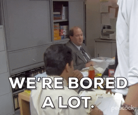 The Office gif. Brian Baumgartner as Kevin sitting at a table with others, deadpan, saying "we're bored a lot."