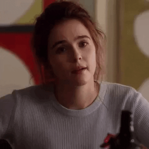 Movie gif. Zoey Deutch as Harper Moore in Set It Up smiles and says "byeeee" as she slides out of the frame.