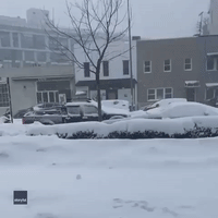 Skier Slides Along Brooklyn Street During Snowstorm