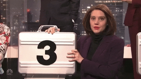 A woman showing a briefcase with the number 3
