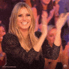 Video gif. Model Heidi Klum claps happily during her time as a judge on America's Got Talent.