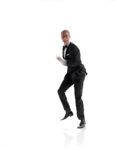 Celebrity gif. Justin Bieber wears a black suit and runs in place super fast. He looks at us, smiling.