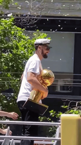 Klay Thompson Holds NBA Championship Trophy During Parade