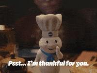 Sponsored gif. Pillsbury Doughboy leans forward and whispers into his hands, "Pssst...I'm thankful for you."