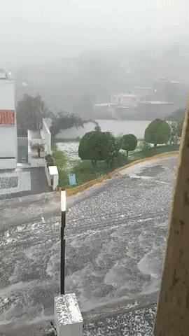 Water Gushes Down Street in Mexico City Suburb as Heavy Hail Falls
