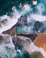 Waves Crash Over Ocean Rockpool in Sydney, Australia