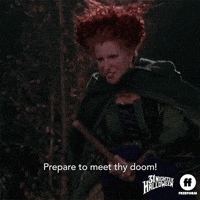 Movie gif. Bette Midler as Winifred in Hocus Pocus rides a broom as she reaches forward menacingly. Text, "Prepare to meet thy doom!"