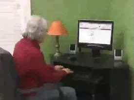 An old women using an computer that happens to have problem.