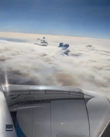 Smoke Plumes Penetrate Clouds as Plane Flies Above California's Dixie Fire