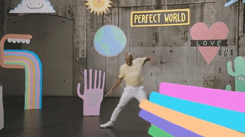 Video gif. A man slides, then dances, throwing his hands into the air in celebration.