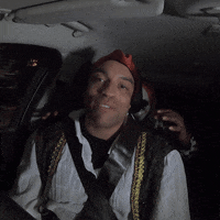 Video gif. Man dressed as a pirate talks to us in his car, unbeknownst to a masked clown lurking in the dark. The clown suddenly grabs him by the shoulders, making him scream.