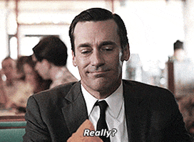 TV gif. Jon Hamm as Don Draper in Mad Men appears annoyed and takes a second before turning his head and asking, “Really?”