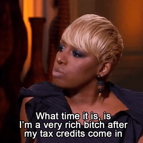 Text gif. Nene Leakes in Real Housewives of Atlanta in a defiant rant with the caption "What time is it is, I'm a very rich bitch after my tax credits come in."