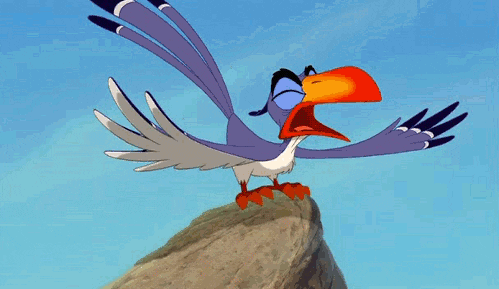 Movie gif. Simba attacks Zazu who is perched on the top of a cliff and attacks him with a huge hug. They both fly off the cliff and Zazu's eyes bug out of his head. Text, "#attackhug."