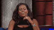TV gif. As guest on The Late Show with Stephen Colbert, Michelle Obama looks frustrated, bowing her head forward onto her fist.