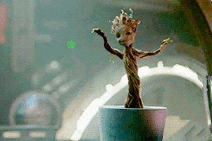 Movie gif. Baby Groot from Guardians of the Galaxy dancing and bopping from inside its pot.