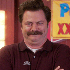 Parks and Recreation gif. Nick Offerman as Ron Swanson laughing and raising an eyebrow.