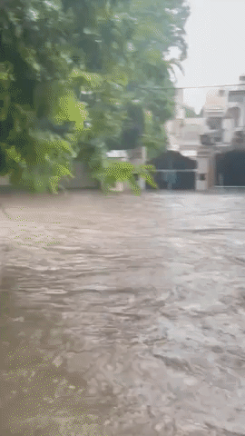 Delhi Residents Wade Through Knee-High Floods