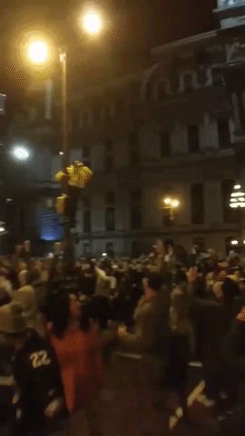 Eagles Fans Climb Lampposts as They Celebrate Super Bowl Victory in Philadelphia