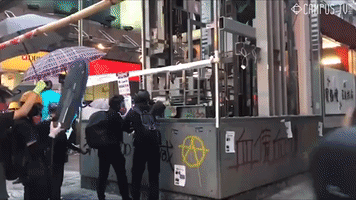 Hong Kong Protester Throws Fire Bomb at MTR Station Elevator