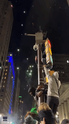 Philadelphia Eagles Fans Climb Traffic Light Pole Following Super Bowl Defeat