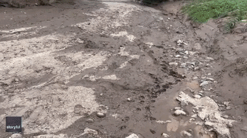 Water Gushes Along Dry Creek Bed Amid Downpours in Northern Arizona
