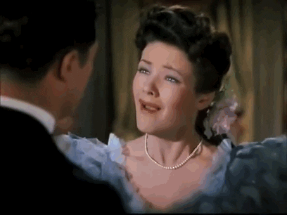 Movie gif. Gene Tierney as Martha in Heaven Can Wait runs off and flops dramatically on a couch, crying.
