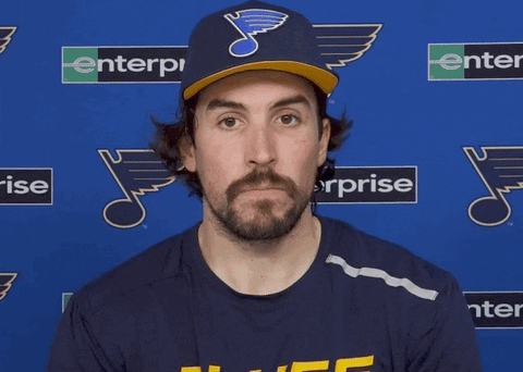 Sports gif. Justin Faulk of the St. Louis Blues hockey team sits for an interview. He considers what's being asked of him before saying, "Yep," clearly and boldly.