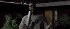 Movie gif. Winston Duke as Gabe from the movie, Us, smacking his hand with a metal baseball bat while exclaiming, "we can get crazy."