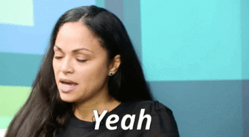 Video gif. Woman turns her head slowly while blinking and then looks over to someone to say, “Yeah.”