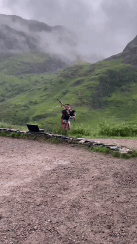 scottish bagpiper wearing tartan in scotland