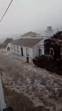 Floodwater Rages Down Street in Azores Town