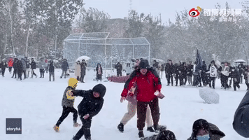 Crowd Holds Epic Snowball Fight During Heavy Blizzard in Shandong, China