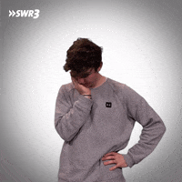 Video gif. German Youtuber, Marcel Bihl, has his chin in his palm looking down. He raises his head up to look at us, with his hand still on his face, with an inquisitive expression. 