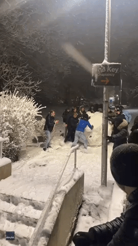 Students' Delight as They Roll Huge Snow Boulder Down Steps at UK University