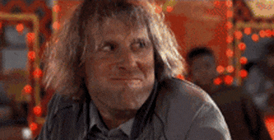 Movie gif. Actors Jeff Daniels and Jim Carrey in Dumb and Dumber exchange looks over a meal before erupting into exaggerated laughter. 