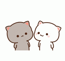 Kawaii gif. A white and a gray cat look at each other and the white cat gives the grey cat a kiss on the cheek. A red heart floats up between them. 