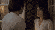 TV gif. Natalia Dyer as Nancy Wheeler and Charlie Heaton as Jonathan Byers from Stranger Things in a dimly lit room. They gaze intensely at each other then move in for a passionate kiss with Nancy grabbing Jonathan's face with both hands.