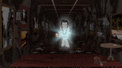 South Park gif. Glowing ghost of Elvis walks down a hallway towards us, pointing to one side and then the other as Kenny trails behind him. Text, in brackets, "Mumbles gibberish."