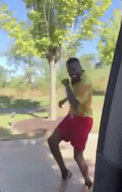 Meme gif. A man known as Mufasa smiling and dancing in a jolly way with angular, robotic moves.